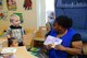 Natasha Sykes, 14th Force Support Squadron Child Development Center direct care staff, reads to children Feb. 5, 2018, on Columbus Air Force Base, Mississippi. Staff at the Columbus CDC take time to ensure that the children are engaged and interactive with the curriculum taught. (U.S. Air Force photo by Airman 1st Class Beaux Hebert)