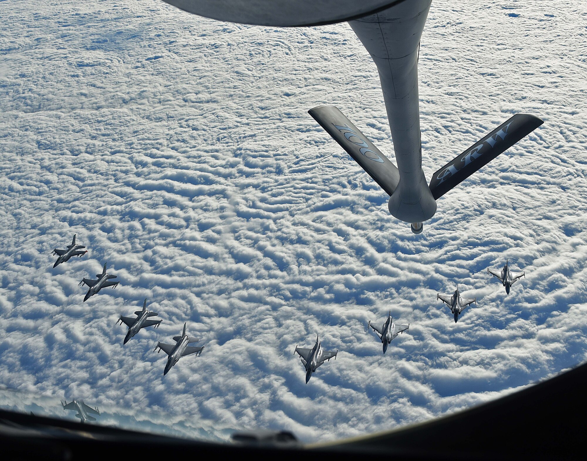 Four U.S. Air Force F-16C Fighting Falcons and four Swedish Air Force JAS 39 Gripens fly in formation together behind a U.S. Air Force KC-135 Stratotanker during aerial refueling training in Swedish airspace, Feb. 8, 2018. The air refueling training is in conjunction with a rotational deployment of F-16Cs from the Ohio Air National Guard’s 180th Fighter Wing to Amari Air Base, Estonia, as part of a Theater Security Package. The training allows the U.S. and Sweden to strengthen interoperability and increase readiness.  (U.S. Air Force photo by Airman 1st Class Luke Milano)