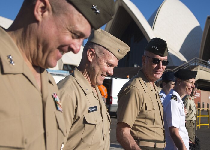 The chairman of the Joint Chiefs of staff and other Joint Staff leaders walk past the Sydney Opera House.