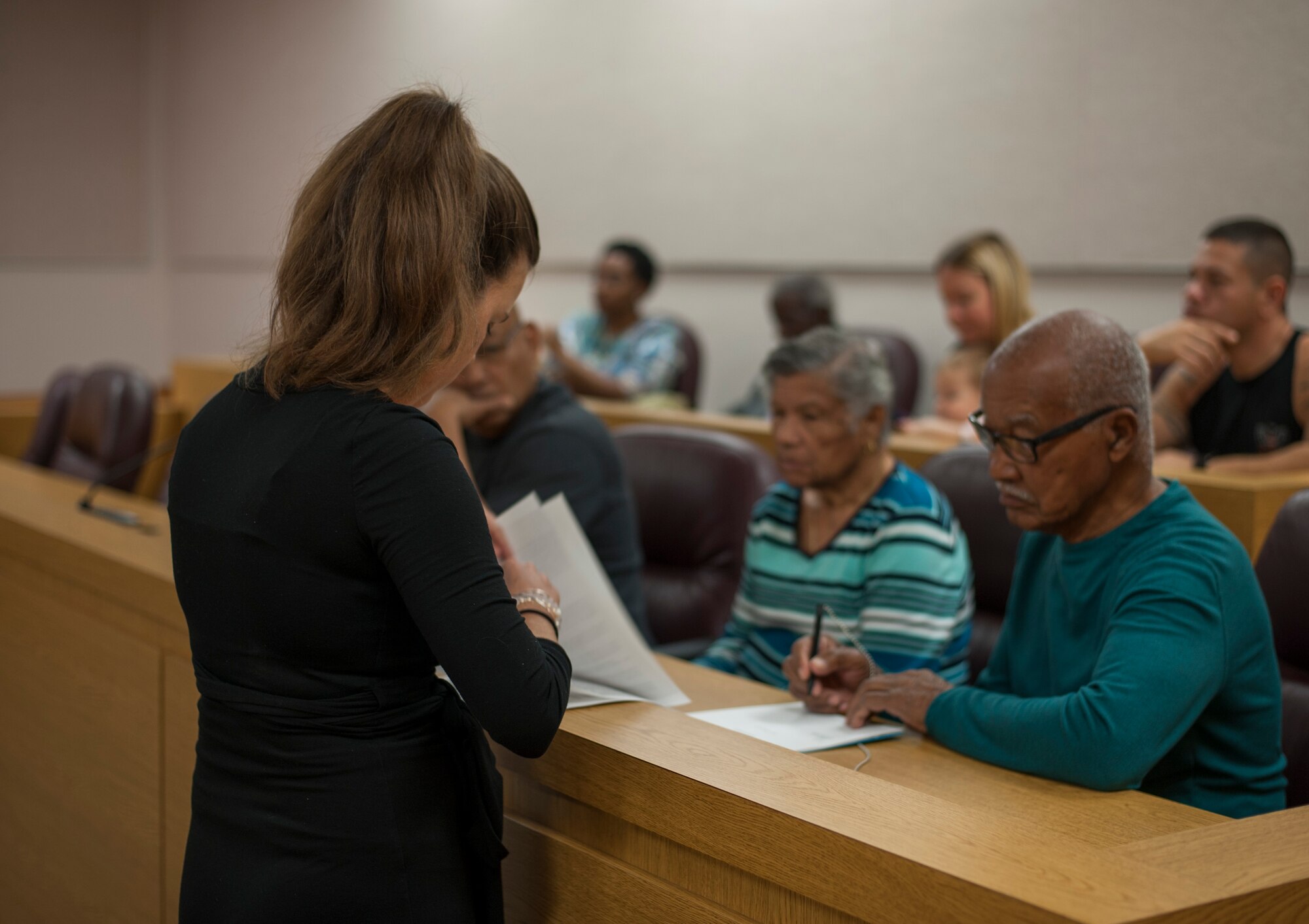 Catherine Woodbury, an administration witness volunteer with the 6th Air Mobility Wing Legal Office, assists retirees with completing wills during Retiree Appreciation Day at MacDill Air Force Base, Fla., Feb. 8, 2018.