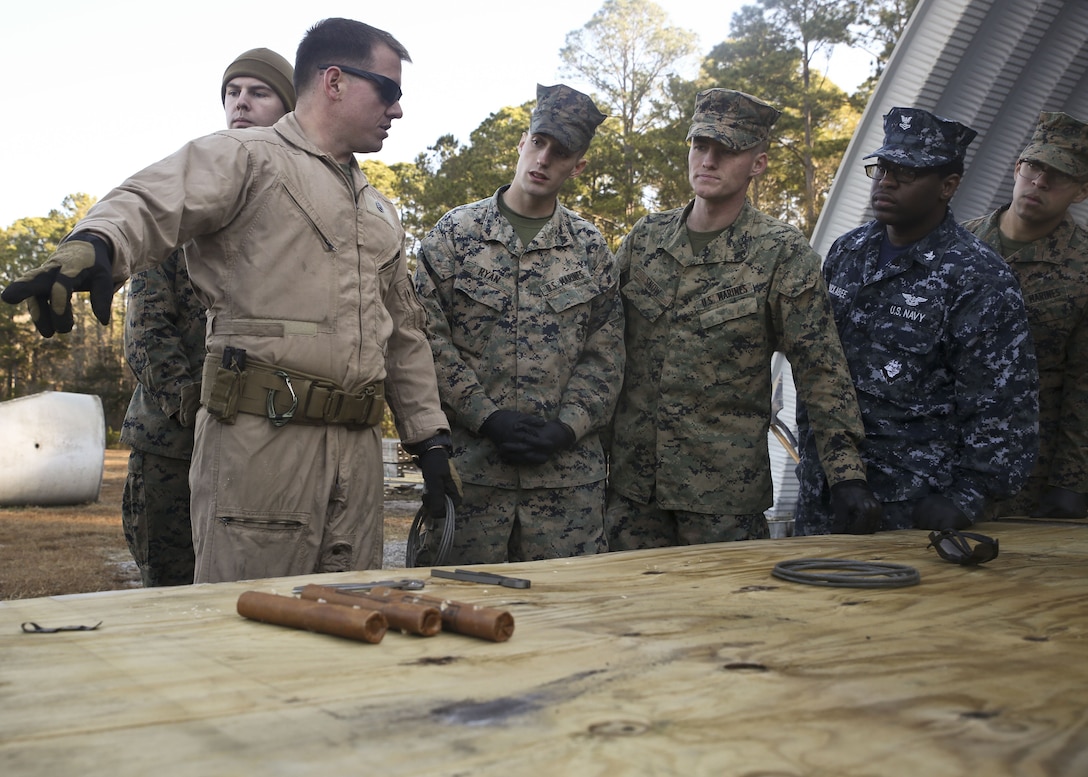 An Explosive Ordnance Disposal Marine gives a lesson to Marines and Sailors during a Demo Day, aboard Marine Corps Air Station Beaufort, Feb. 1. EOD hosted the Demo Day so other Marines and Sailors could see how they conduct operations.