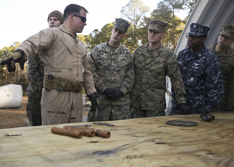 An Explosive Ordnance Disposal Marine gives a lesson to Marines and Sailors during a Demo Day, aboard Marine Corps Air Station Beaufort, Feb. 1. EOD hosted the Demo Day so other Marines and Sailors could see how they conduct operations.