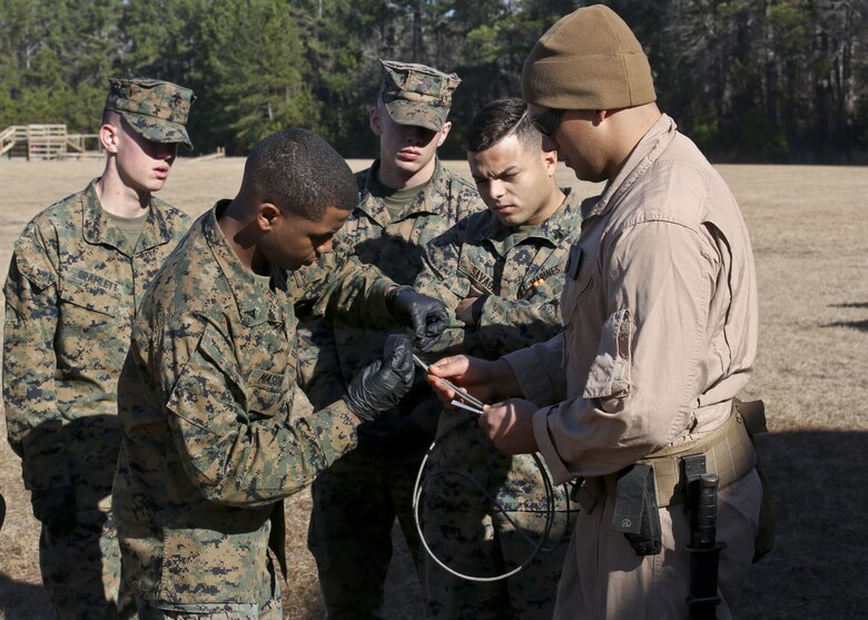 Staff Sgt. Steve Gomez watches as Lance Cpl. Darius Mason practices with detonating cord during a Demo Day, aboard Marine Corps Air Station Beaufort, Feb. 1.Gomez an EOD Technician with Marine Wing Support Detachment 31 and Mason is an administrator with Headquarters and Headquarters Squadron.