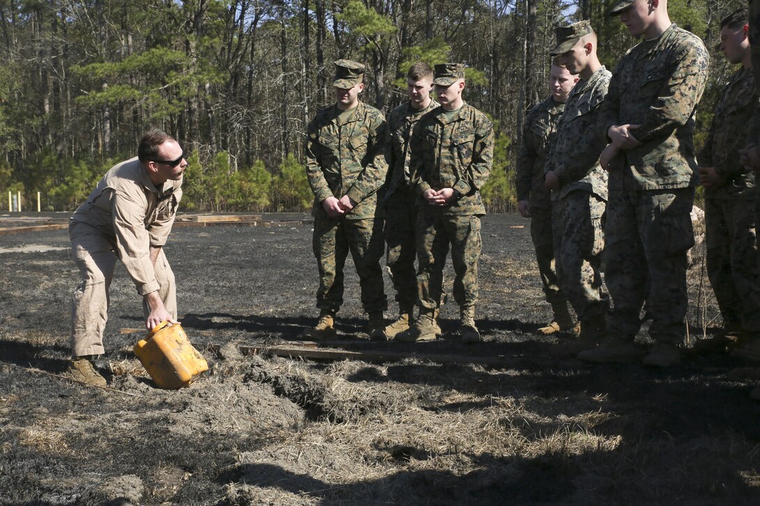 Staff Sgt. Matthew Eades shows Marines and Sailors the remains of materials after a detonation, aboard Marine Corps Air Station Beaufort, Feb. 1. Staff Sergeant Eades is an EOD Technician with Marine Wing Support Detachment 31.