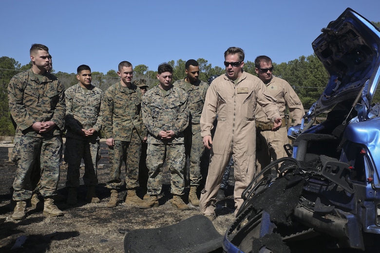 An Explosive Ordnance Disposal Marine shows Marines and Sailors the remains of a car after a detonation, aboard Marine Corps Air Station Beaufort, Feb. 1. EOD hosted the Demo Day so other Marines and Sailors could see how they conduct operations.