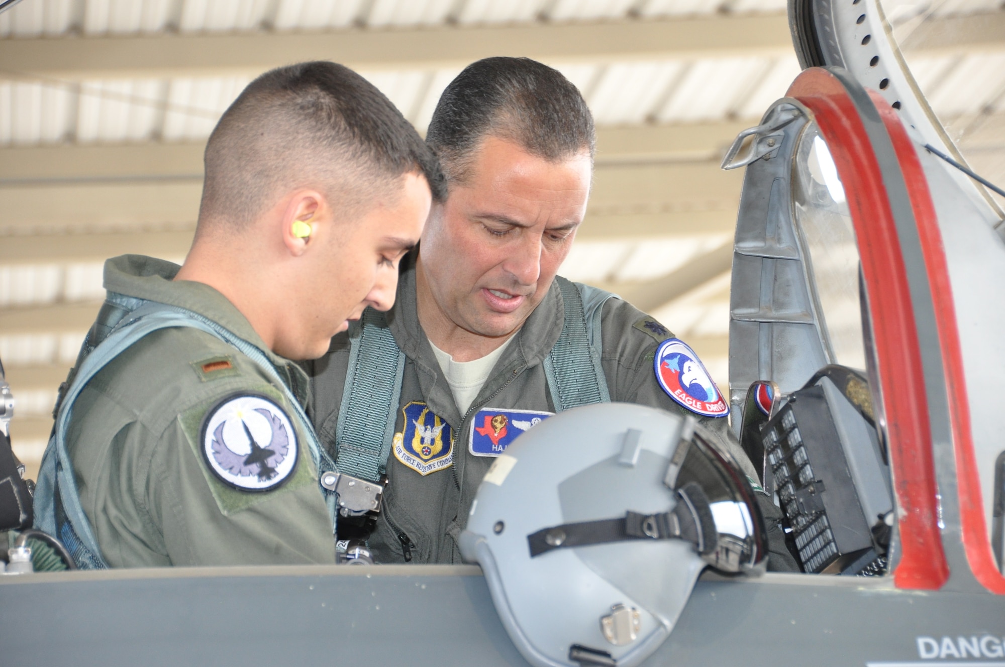 Lt. Col. Joe Mirarchi, mission commander, checks to ensure 2nd Lt. Chris Mirarchi is correctly situated in the aircraft prior to the lieutenant colonel’s fini flight, and the lieutenant’s first Air Force sortie. (U.S. Air Force photo by Debbie Gildea)
