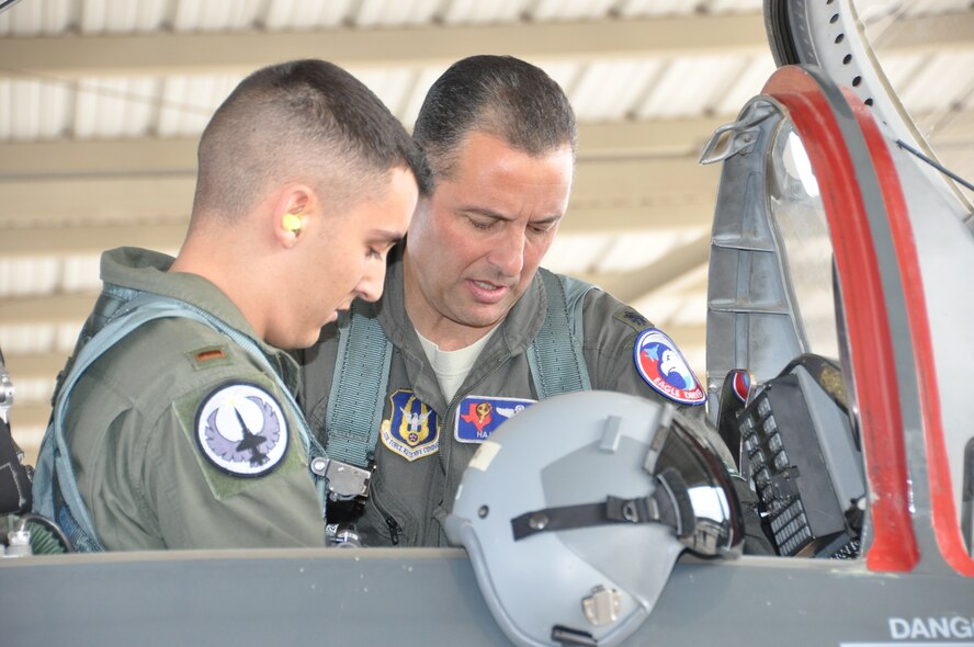 Lt. Col. Joe Mirarchi, mission commander, checks to ensure 2nd Lt. Chris Mirarchi is correctly situated in the aircraft prior to the lieutenant colonel’s fini flight, and the lieutenant’s first Air Force sortie. (U.S. Air Force photo by Debbie Gildea)