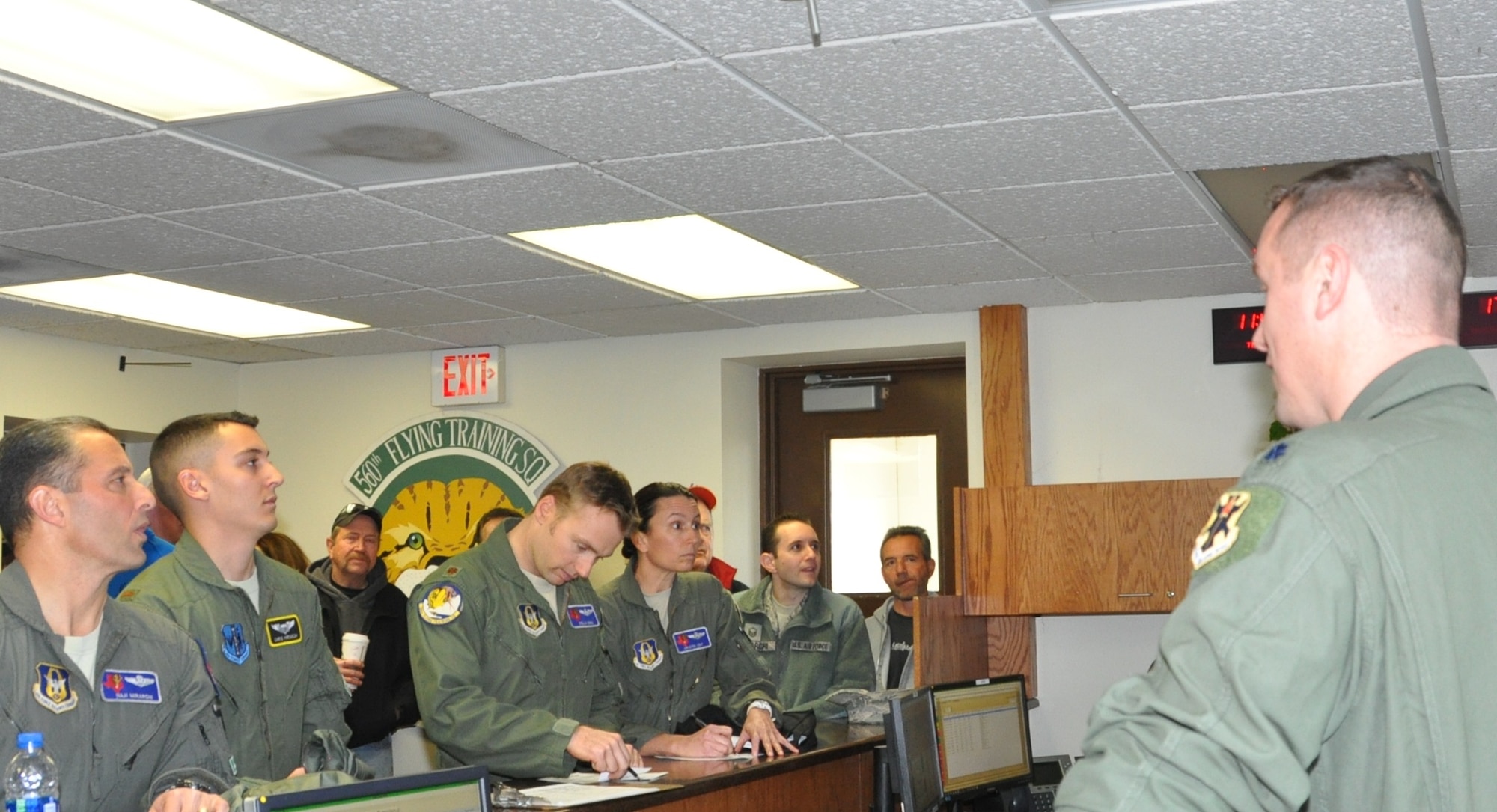 The Mirarchis, left, join squadron teammates who will fly the four-ship mission with them during the lieutenant colonel’s fini flight. Mission crew members included Maj. Klayton Ives (ship one, backseat flying with Colonel Mirarchi), Maj. Colin Cima (ship two, front seat, flying with Lieutenant Mirarchi), Lt. Col. Kristen Kent (ship three, front seat), Maj. Mark Youens (ship three, back seat), Lt. Col. James Miller (ship four, front seat) and Lt. Col. Katherine Burkhead (ship four, back seat). (U.S. Air Force photo by Debbie Gildea).