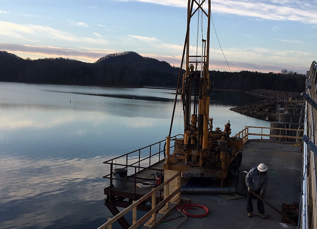 U.S. Army Corps of Engineers, Mobile District, Senior Driller Eddie in January Woods drills holes in the Carters Reregulation Dam, Jan. 24, as part of a multi-district effort to cut a slot in the dam and relieve stress caused by concreate expansion. The holes will allow the Nashville District to feed diamond rope through the hole to cut a slot dam to relieve the stress.
