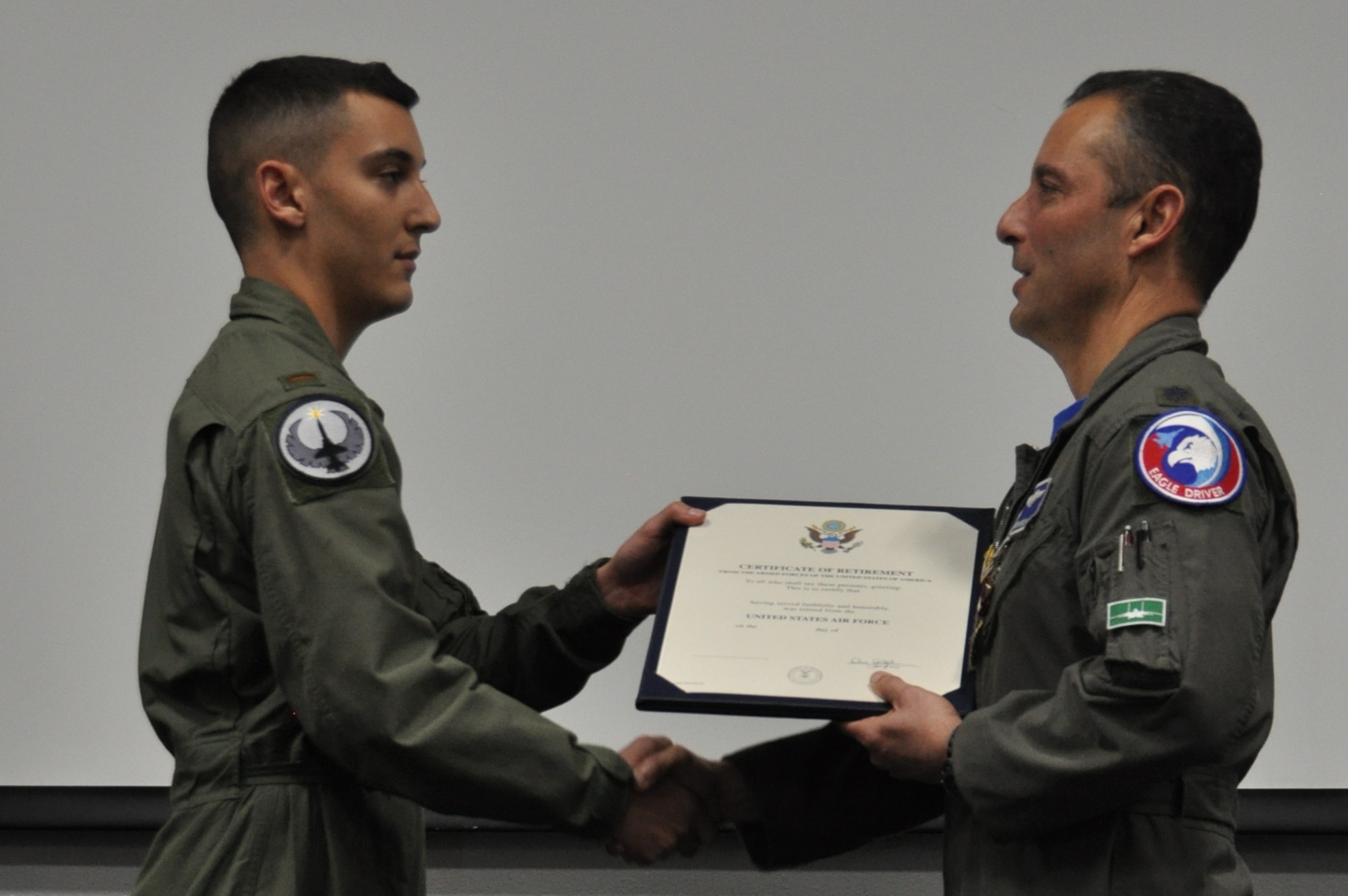 Lieutenant Mirarchi presents the retirement certificate to his father during the formal retirement ceremony. (U.S. Air Force photo by Debbie Gildea)