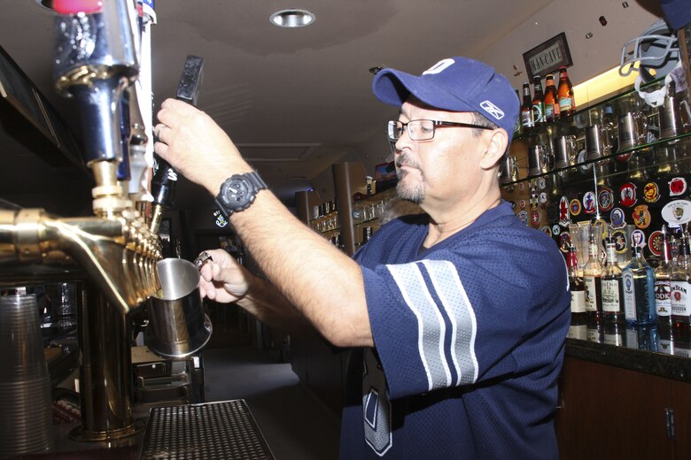 Steve Tittnich, bartender, Brass and Rockers, serves drinks to Combat Center patrons in the Brass and Rockers Club during Super Bowl LII aboard the Marine Corps Air Ground Combat Center, Twentynine Palms, Calif., Feb. 4, 2018. The Brass and Rockers Club, formerly known as the Officers' Club opened its doors for members of the installation to enjoy the super bowl. (U.S. Marine Corps photo by Cpl. Natalia Cuevas)