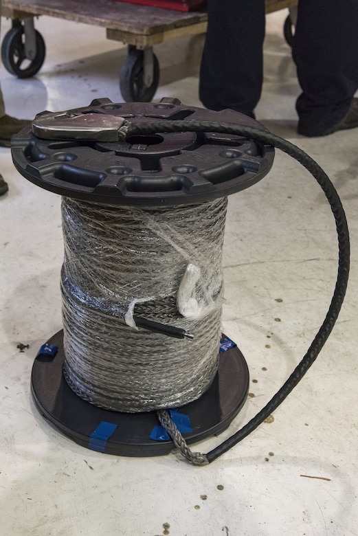 Application engineers from Samson Rope, Ferndale, Wash., brought the proposed synthetic winch cable for C-17 Globemaster III maintainers to wind on a winch assembly, Jan. 30, 2018, at Dover Air Force Base, Del. The 280-foot synthetic winch cable weighs 14 pounds and is 83 percent lighter than the current 80 pound steel wire cable. (U.S. Air Force photo by Roland Balik)