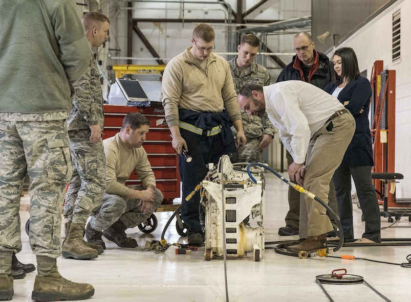 Justin Smoak, Samson Rope application engineering manager, Ferndale, Wash., observes how the synthetic winch line feeds into a C-17 Globemaster III winch assembly, Jan. 30, 2018 at Dover Air Force Base, Del. Smoak watched maintainers attach and wind the cable onto the winch while looking for any potential issues. (U.S. Air Force photo by Roland Balik)