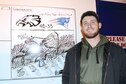 Kody Kolke, a hazardous material handler with the 565th Aircraft Maintenance Squadron, takes a few minutes out of his work day to help boost morale by drawing funny or patriotic scenes on a whiteboard in a heavily-travelled hallway in Bldg. 2121.