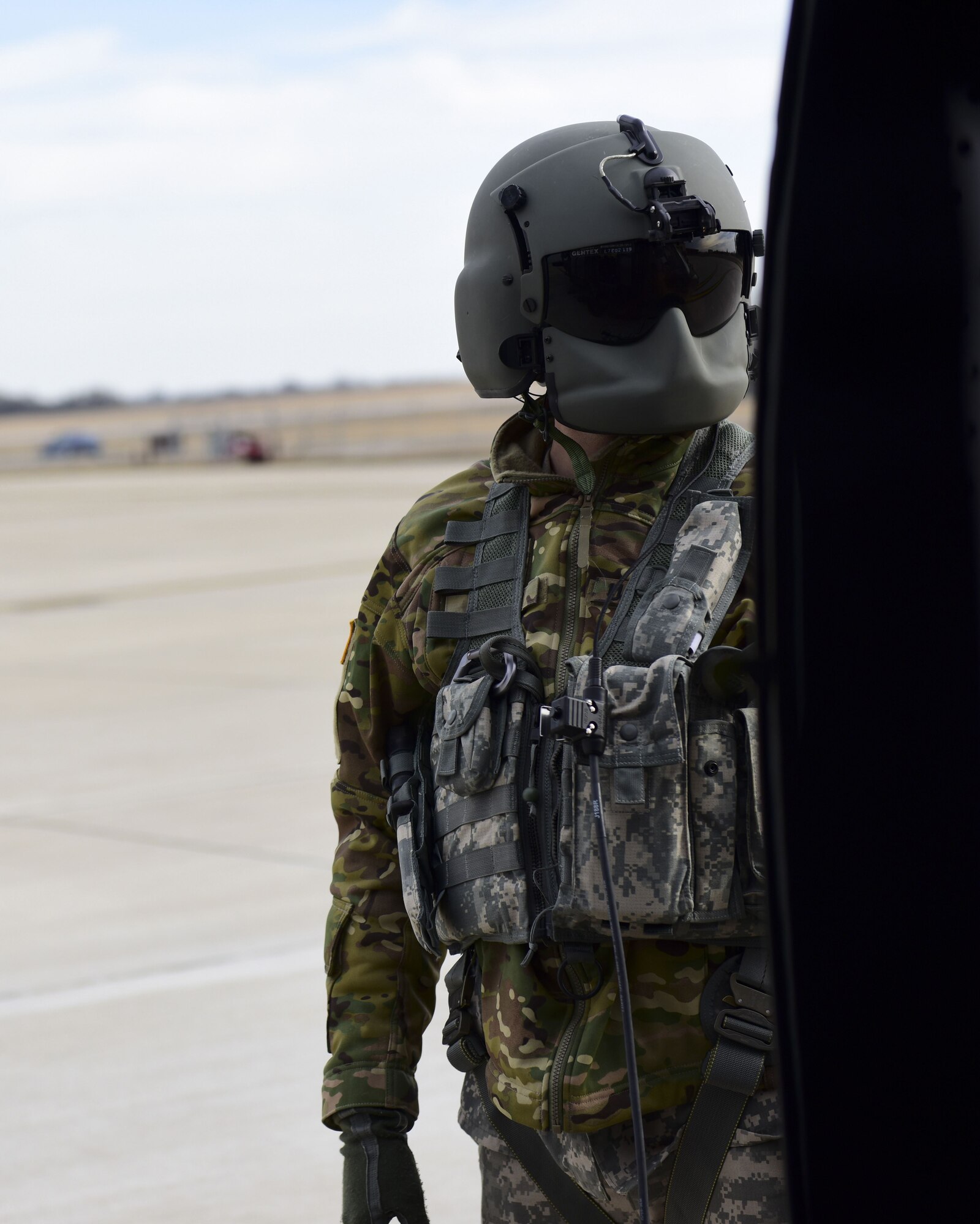 A U.S. Army crew chief with the 1-135th Assault Helicopter Battalion monitors a UH-60 Black Hawk before take off during a joint training at Whiteman Air Force Base, Mo., Jan. 31, 2018. In addition to establishing a partnership, the purpose of the training was to familiarize Joint Terminal Attack Controllers from the 7th Air Support Operations Squadron located in Fort Bliss, Texas, with the assets available at Whiteman AFB that are used in a multi-domain fight.
