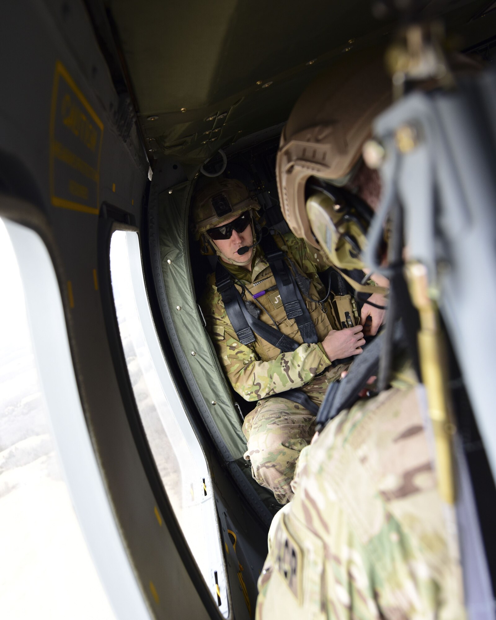 A Joint Terminal Attack Controller rides in a UH-0 Black Hawk during a joint training at Warshaw, Mo., Jan. 31, 2018. This training allowed JTAC to work with to work together units from Whiteman Air Force Base, Mo., to help standardize how JTACs are integrated into a multi-domain fight. (U.S. Air Force by Staff Sgt. Danielle Quilla)