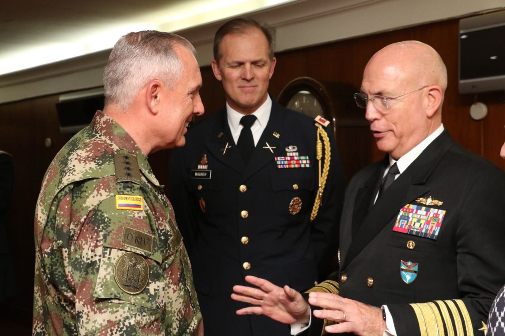 Military officers speak to one another.