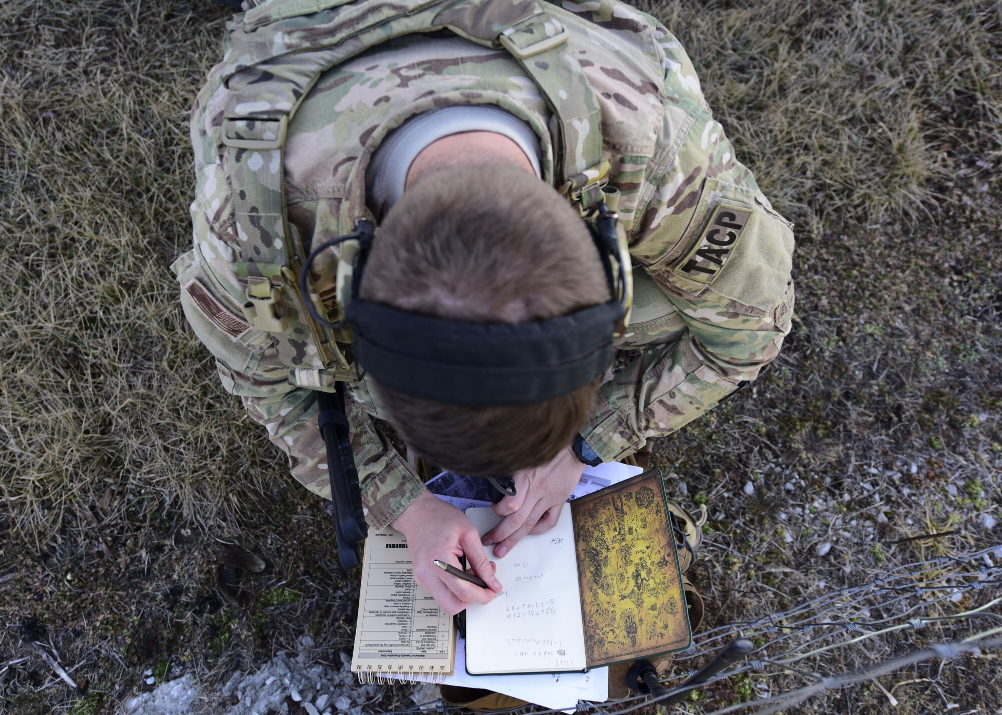 A Joint Terminal Attack Controller from the 7th Air Support Operations Squadron, located in Fort Bliss, Texas, writes down information during a joint training at Warshaw, Mo., Jan. 31, 2018. JTACs are personnel who are authorized to call airstrikes and help coordinate close-air-support missions. (U.S. Air Force by Staff Sgt. Danielle Quilla)