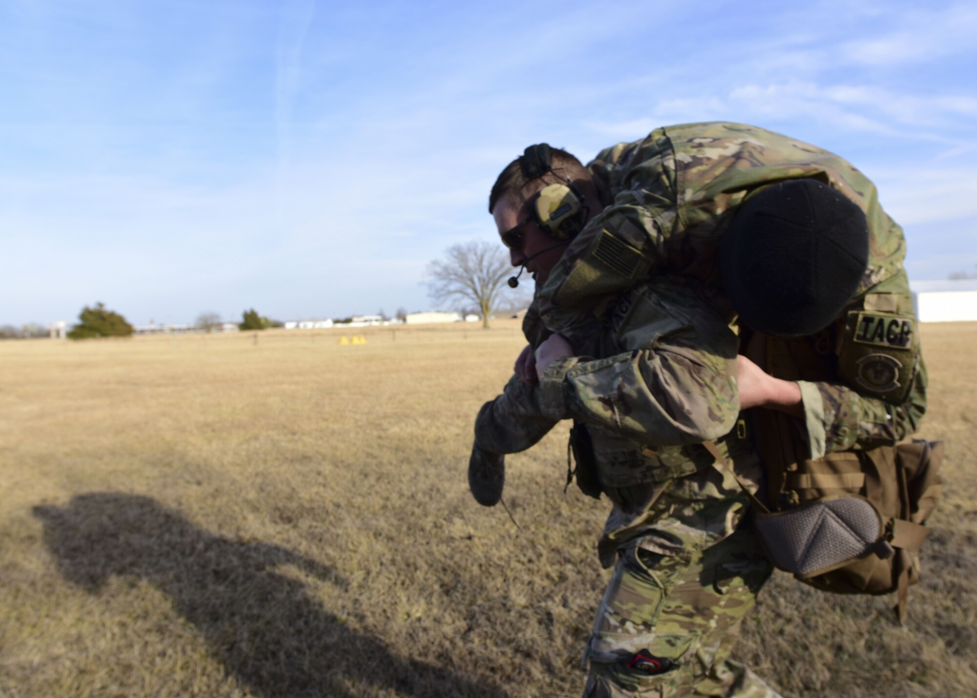 A Joint Terminal Attack Controller assigned to the 7th Air Support Operations Squadron, located in Fort Bliss, Texas, carries a team member during a joint training mission at Warsaw, Mo., Jan. 31, 2018. This training allowed units from Whiteman Air Force Base, Mo., work together with members from the 7th ASOS to standardize how JTACs are integrated into a multi-domain fight. (U.S. Air Force by Staff Sgt. Danielle Quilla)