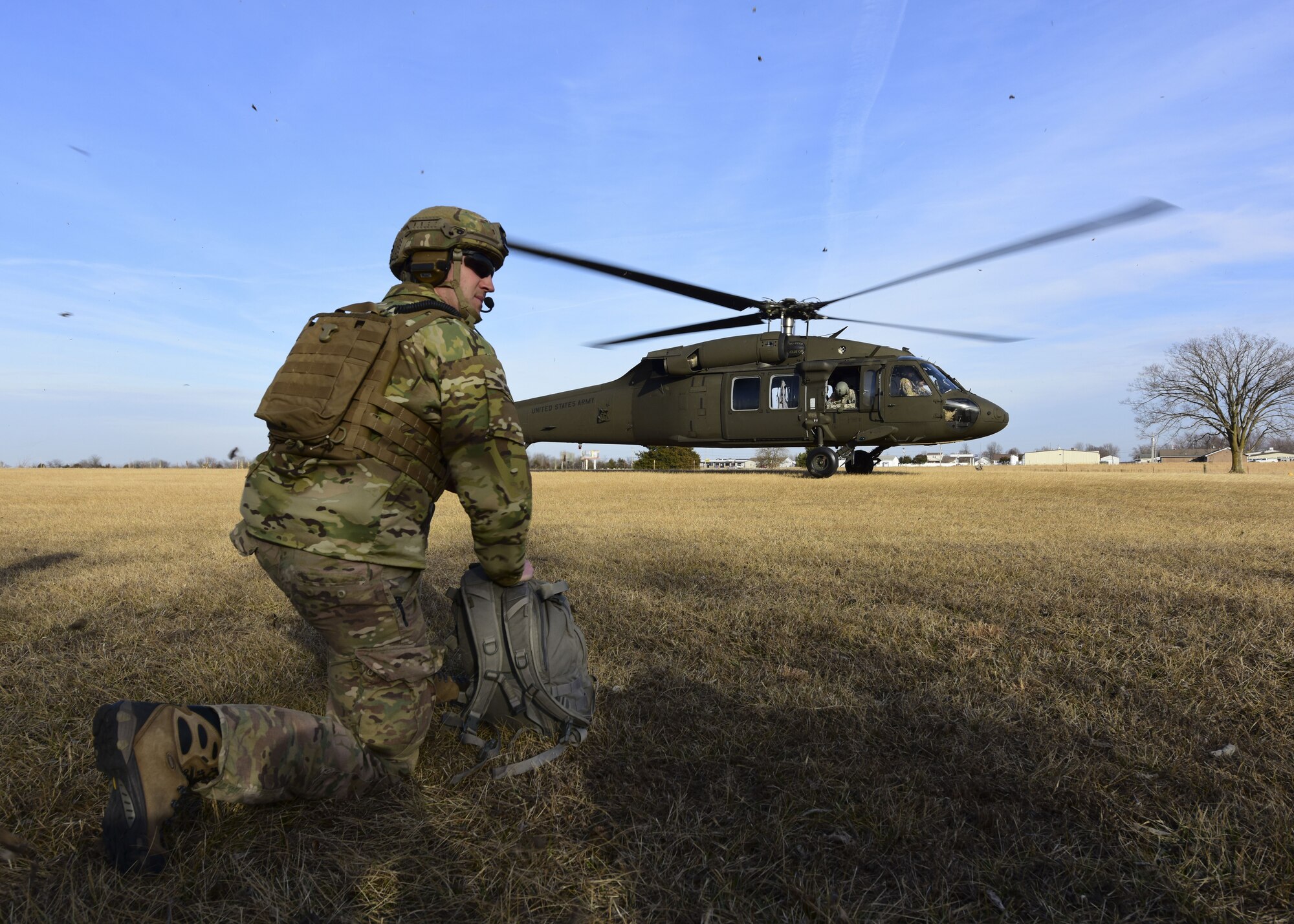 A Joint Terminal Attack Controller assigned to the 7th Air Support Operations Squadron, located in Fort Bliss, Texas,  waits for a UH-0 Black Hawk land during a joint training at Warshaw, Mo., Jan. 31, 2018. JTACs are personnel who are authorized to call airstrikes and help coordinate close-air-support missions. (U.S. Air Force by Staff Sgt. Danielle Quilla)
