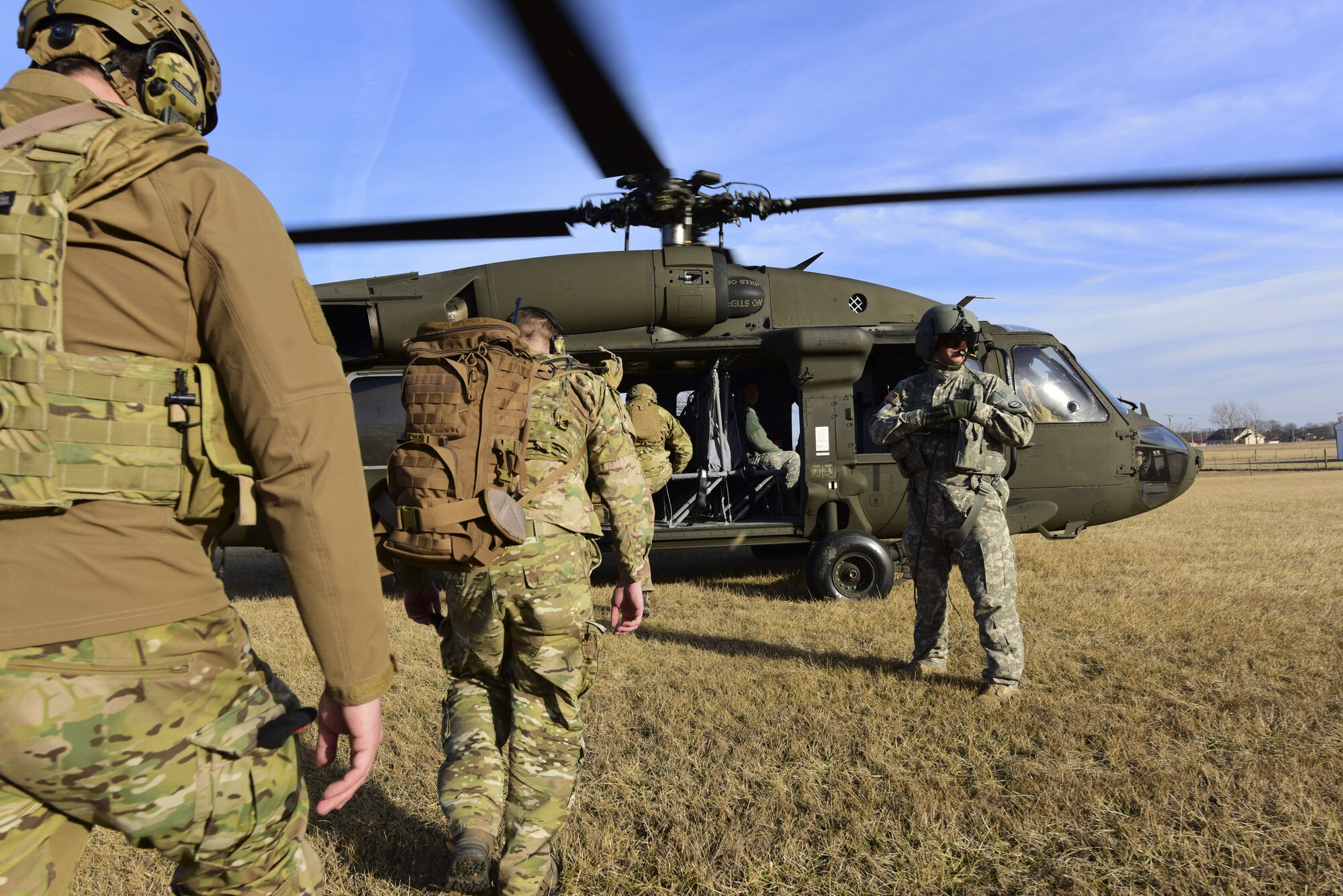 Joint Terminal Attack Controllers assigned to the 7th Air Support Operations Squadron from Fort Bliss,Texas, enter a UH-0 Black Hawk during a joint training mission at Warsaw, Mo., Jan. 31, 2018. The joint training, titled Truman Relief, involved the 509th Bomb Wing and 1-135th Assault Helicopter Battalion from Whiteman Air Force Base, Mo. (U.S. Air Force by Staff Sgt. Danielle Quilla)