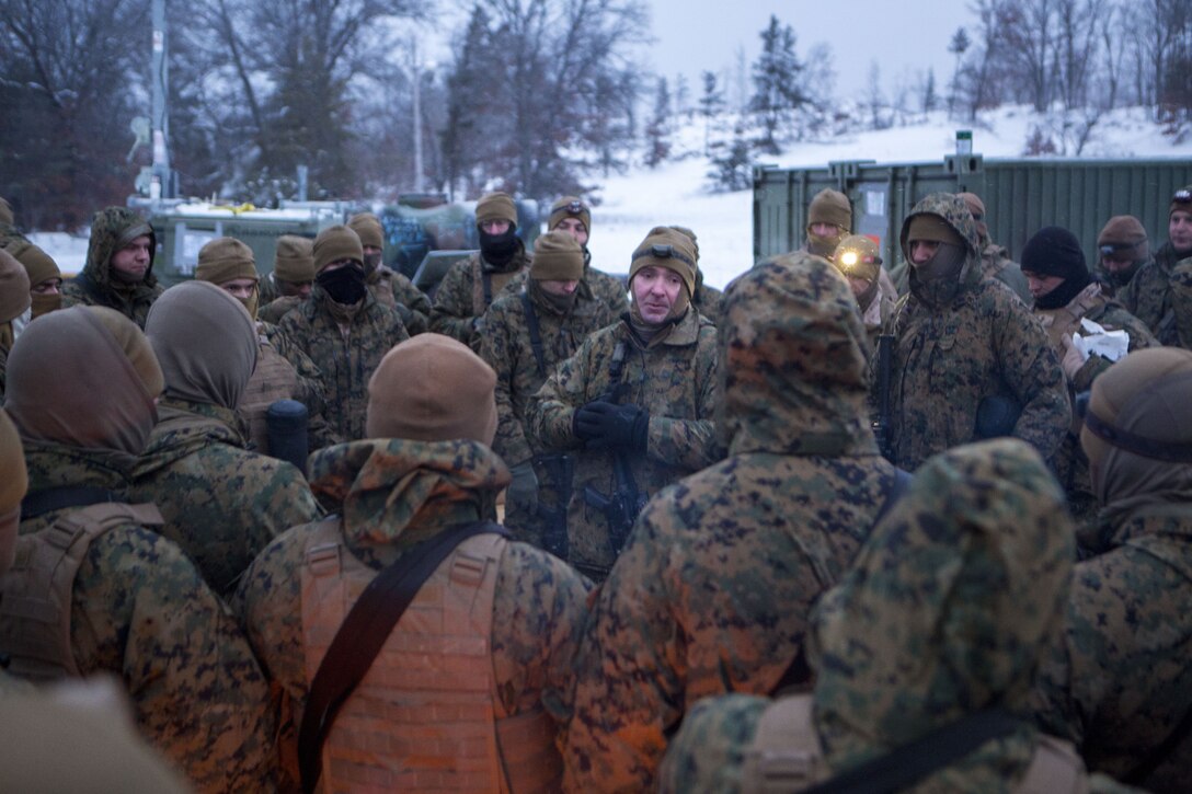 Capt. Andrew Bender, commanding officer of Company F, 4th Tank Battalion, 4th Marine Division, talks to his Marines about the importance of communication during cold weather training at exercise Winter Break 2018, near Camp Grayling, Michigan, Feb. 8, 2018. The safety brief kicked of day two the training exercise during which Fox Co. Marines rehearsed formations, conducted advanced land navigation and terrain identification and performed preventative maintenance checks and services on their armored vehicles and equipment while increasing their operational capacity in single degree temperatures and snow covered terrain.