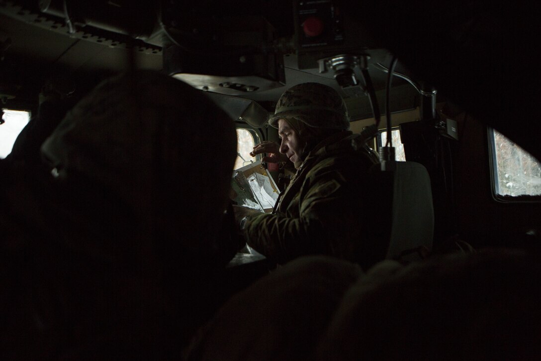 Capt. Andrew Bender, commanding officer of Company F, 4th Tank Battalion, 4th Marine Division, reviews checkpoints on a map overlay during exercise Winter Break 2018, near Camp Grayling, Michigan, Feb. 8, 2018. Reserve Marines spend two weeks each year building their capabilities at an Annual Training exercise. This year, the Camp Lejeune, North Carolina, based tank company is taking advantage of Camp Grayling’s rugged training areas to test their offensive, defensive and maneuver capabilities in an austere cold weather environment.