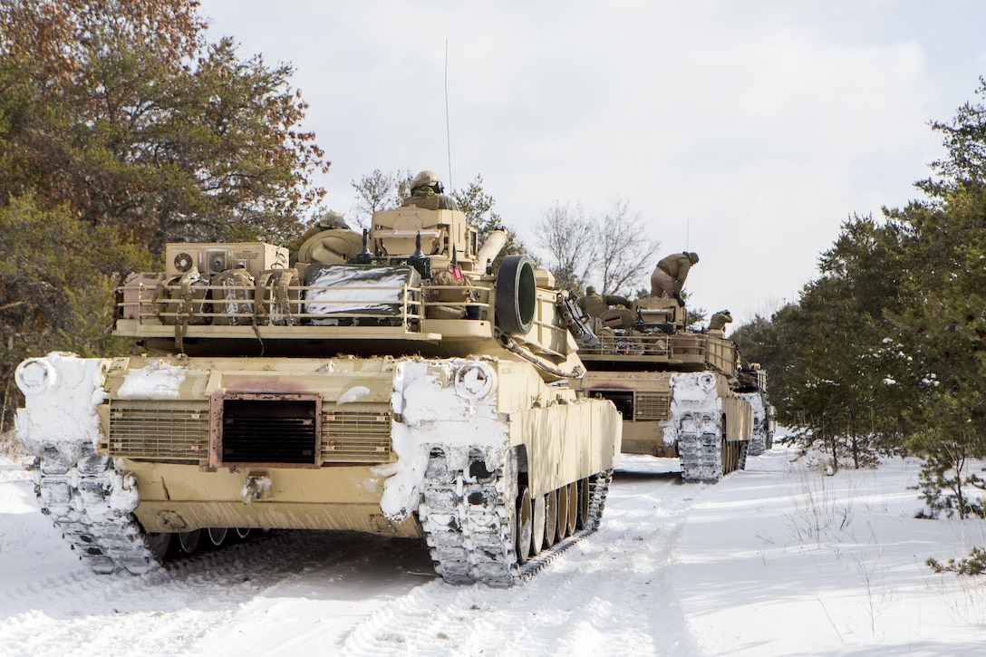 Marines with Company F, 4th Tank Battalion, 4th Marine Division, pause before convoying to a training area during exercise Winter Break 2018 near Camp Grayling, Michigan, Feb. 8, 2018. During training day two of Winter Break 18, Fox Co. Marines rehearsed formations, conducted advanced land navigation and terrain identification and performed preventative maintenance checks and services on their armored vehicles and equipment while increasing their operational capacity in single degree temperatures and snow covered terrain.