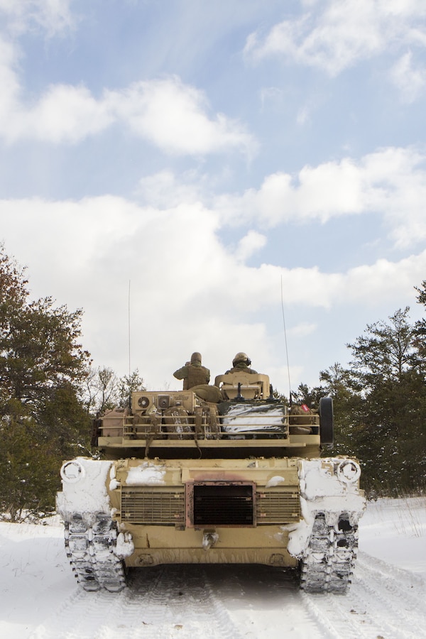 Marines with Company F, 4th Tank Battalion, 4th Marine Division, pause to check the scheme of maneuver before a platoon formation rehearsal during exercise Winter Break 2018 near Camp Grayling, Michigan, Feb. 8, 2018. Winter Break 18 challenges Marines of Fox Co., 4th Tank Bn. to contend with employment problems caused by extreme cold weather and snow and adapt to the operational challenges of a severe climate.