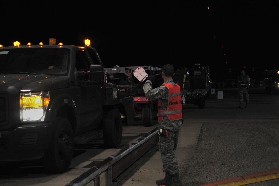 U.S. Air Force Airman 1st Class Jarett Cash, 355th Logistics Readiness Squadron air terminal representative, directs a truck onto a weigh station at Davis-Monthan Air Force Base, Ariz., Feb. 9, 2018.