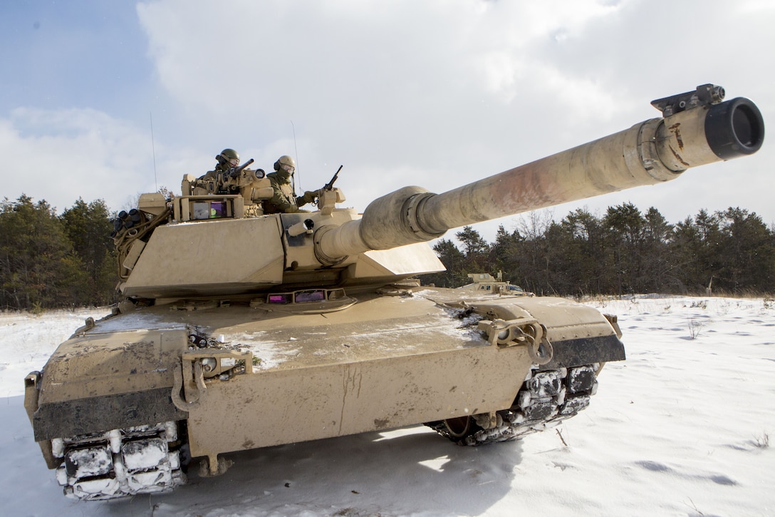 Marines with Company F, 4th Tank Battalion, 4th Marine Division, pause to check the scheme of maneuver before a platoon formation rehearsal during exercise Winter Break 2018 near Camp Grayling, Michigan, Feb. 8, 2018. Winter Break 18 challenges Marines of Fox Co., 4th Tank Bn. to contend with employment problems caused by extreme cold weather and snow and adapt to the operational challenges of a severe climate.