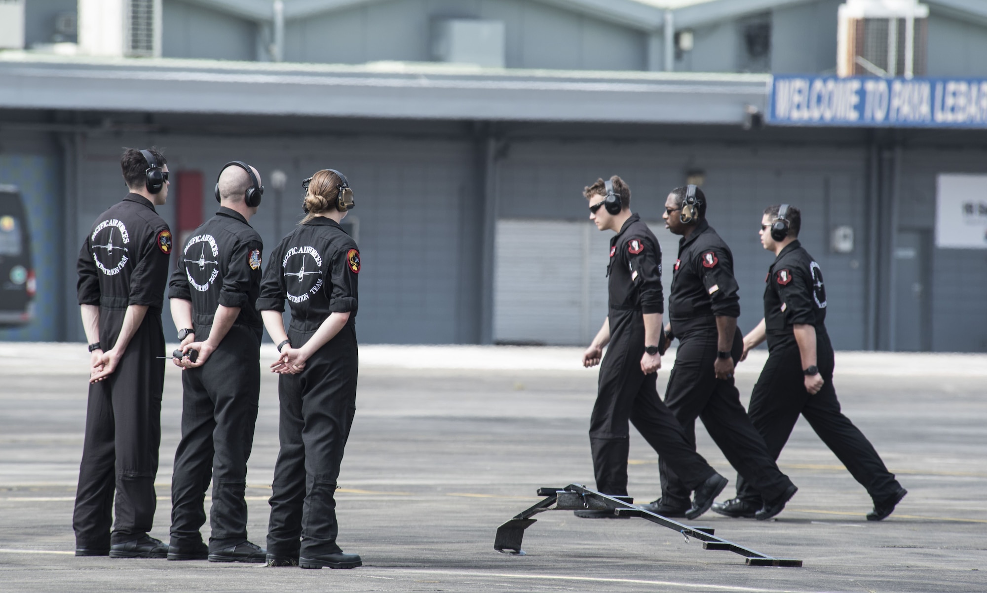 U.S. Air Force Airmen with the Pacific Air Forces' F-16 Demonstration Team march to their finishing position prior to a practice at Paya Lebar Air Base, Singapore, Feb. 3, 2018.