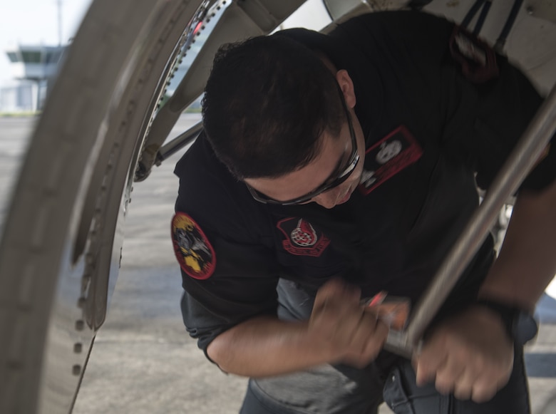 U.S. Air Force Staff Sgt. Steven Pedrick, a Pacific Air Forces' F-16 Demonstration Team crew chief, pumps the jet fuel sorter prior to a practice at Paya Lebar Air Base, Singapore, Feb. 3, 2018.