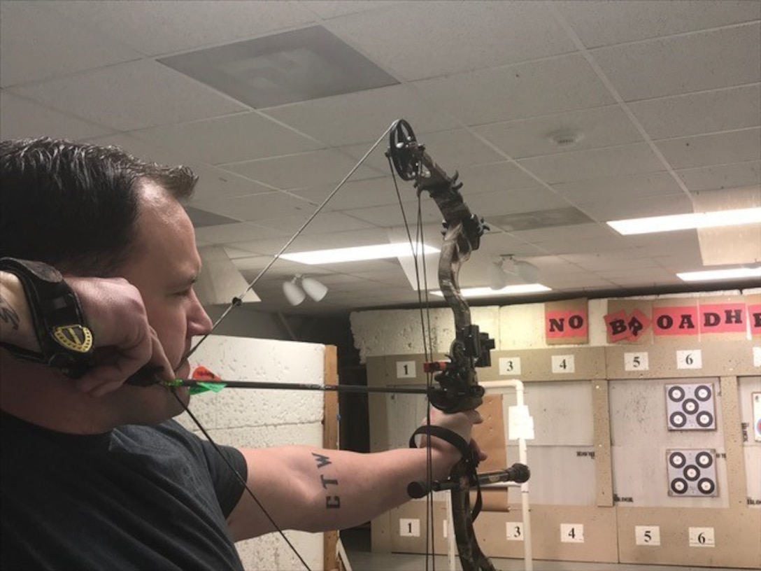 Soldier draws his bow while training for archery competition.