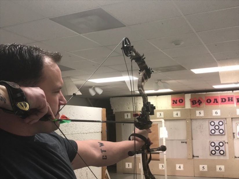 Soldier draws his bow while training for archery competition.
