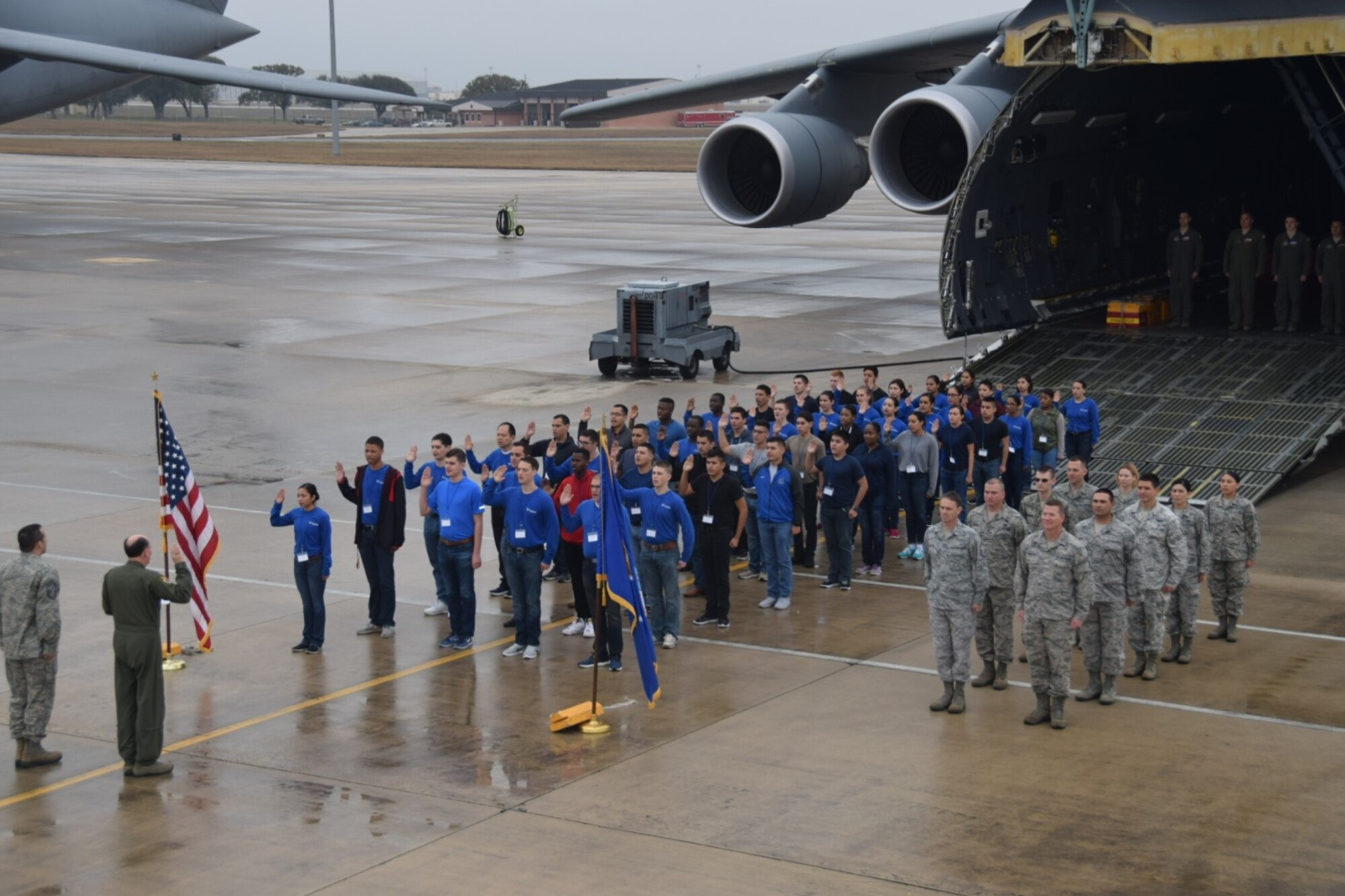 Despite the wet weather, Col. Thomas K. Smith, Jr., 433rd Airlift Wing commander, administers the Oath of Enlistment to 48 future 433rd Airlift Wing Reserve Citizen Airmen Feb. 10, 2018 at Joint Base San Antonio-Lackland, Texas. The future Airmen, members of the Delayed enlistment Training Flight, were supported by Chief Master Sgt. Brian Pinsky, 433rd AW command chief, 10 recruiters, load masters and a flight engineer. (U.S. air Force photo/Tech. Sgt. Carlos J. Trevino)