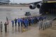 Despite the wet weather, Col. Thomas K. Smith, Jr., 433rd Airlift Wing commander, administers the Oath of Enlistment to 48 future 433rd Airlift Wing Reserve Citizen Airmen Feb. 10, 2018 at Joint Base San Antonio-Lackland, Texas. The future Airmen, members of the Delayed enlistment Training Flight, were supported by Chief Master Sgt. Brian, 433rd AW command chief, 10 recruiters, load masters and a flight engineer. (U.S. air Force photo/Tech. Sgt. Carlos J. Trevino)