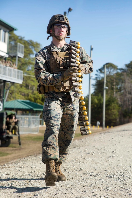 Marine Corps Lance Cpl. Cole Hanks approaches the gun line for his turn to fire a 40 mm MK-19 grenade launcher at Camp Lejeune, N.C.