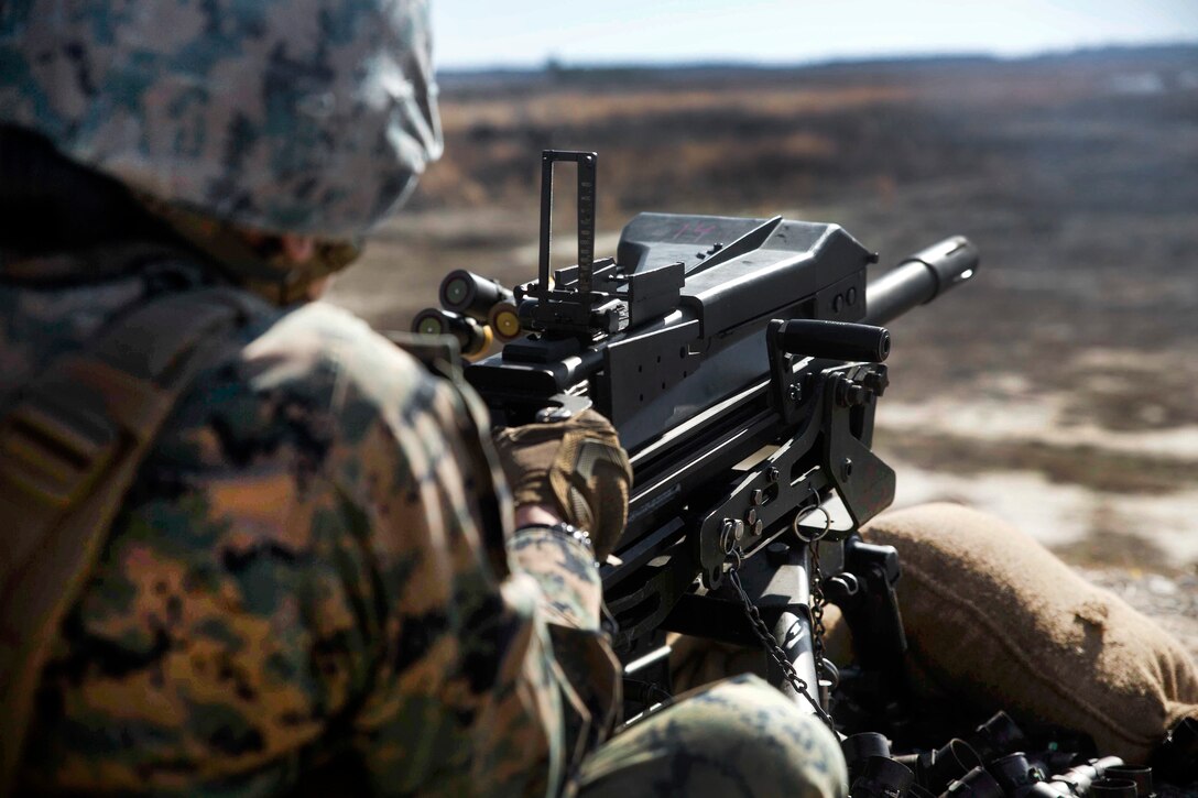 Marine Corps Lance Cpl. Melissa Bustamante fires a 40 mm MK-19 grenade launcher during a live-fire range at Camp Lejeune, N.C.