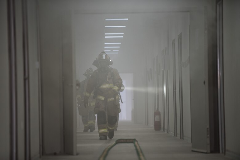 Firefighters assigned to the 332d Expeditionary Civil Engineer Squadron clear rooms after responding to a simulated structure fire as part of a coalition emergency response exercise February 9, 2017 at an undisclosed location in Southwest Asia. The scenario called for the Airmen to locate and rescue a missing person trapped in the smoke. (Air Force photo by Staff Sgt. Joshua Kleinholz)