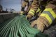 Firefighters assigned to the 332d Expeditionary Civil Engineer Squadron respond to a simulated structure fire during a coalition emergency response exercise February 9, 2017 at an undisclosed location in Southwest Asia. Structures with complex floorplans require fire protection teams to prepare hundreds of feet of hose in order to ensure enough reach to extinguish the fire at its source. (Air Force photo by Staff Sgt. Joshua Kleinholz)