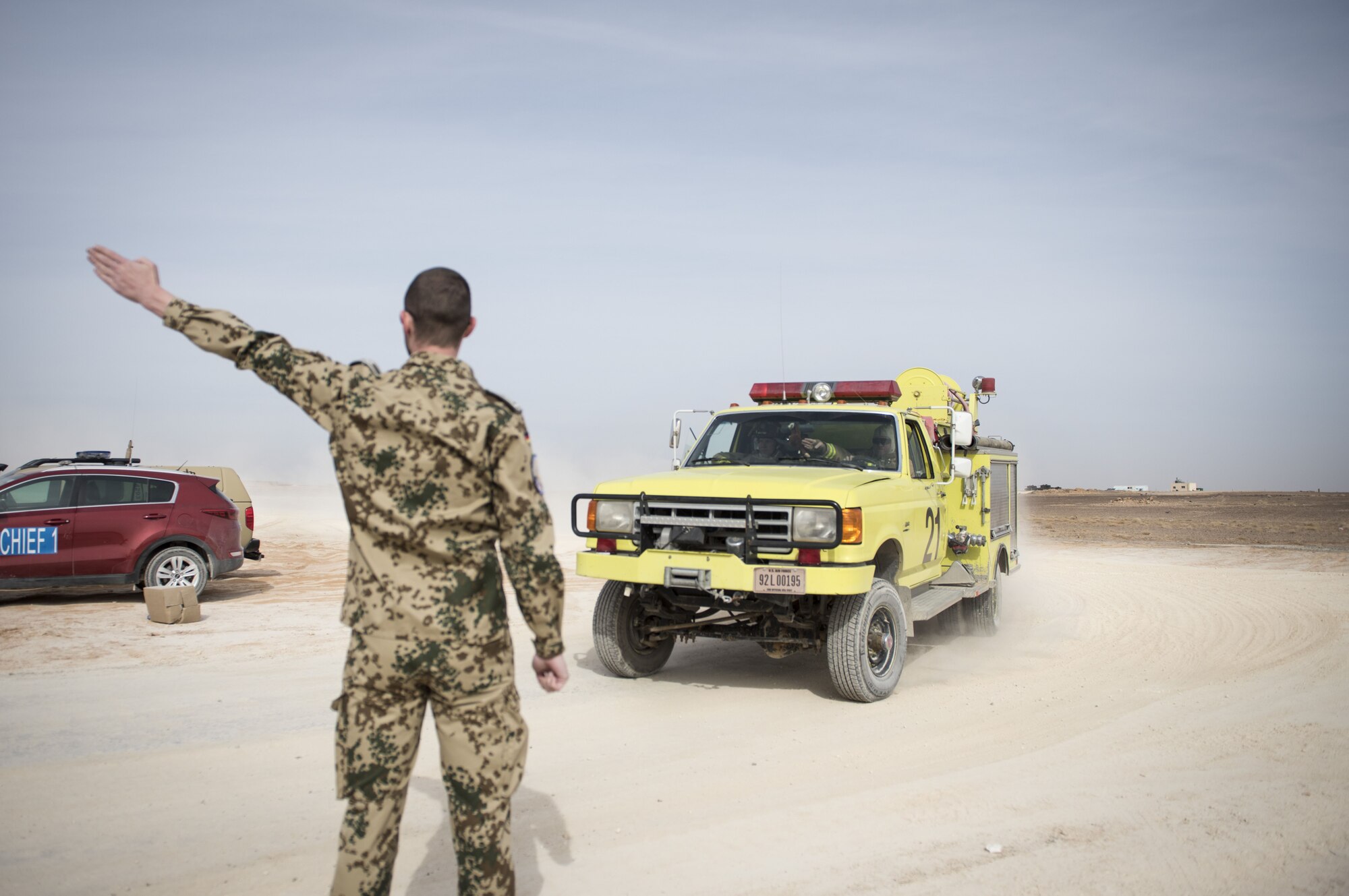 Firefighters assigned to the 332d Expeditionary Civil Engineer Squadron are directed to the scene of a simulated structure fire during a coalition emergency response exercise February 9, 2017 at an undisclosed location in Southwest Asia. The exercise was designed to evaluate response times and streamlines reporting procedures. (Air Force photo by Staff Sgt. Joshua Kleinholz)