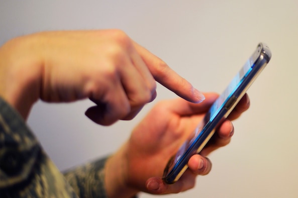 U.S. Air Force Senior Airman Devin Rumbaugh, 86th Airlift Wing public affairs photojournalist, checks his social media feed on Ramstein Air Base, Germany, Feb. 7, 2018. Social media is a popular tool for military members to connect and share experiences. (U.S. Air Force photo by Senior Airman Joshua Magbanua)