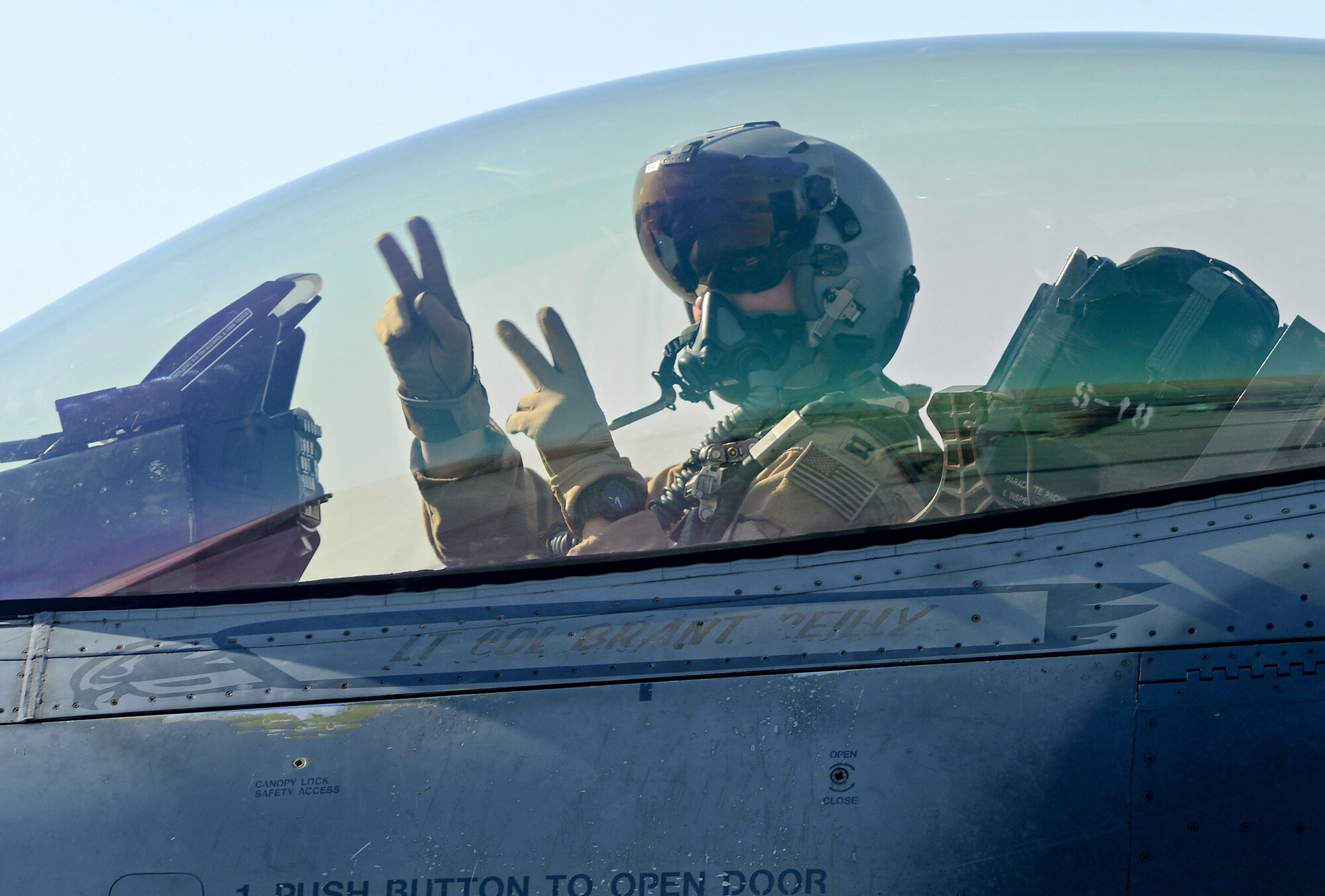 “Slapshot”, 77th Expeditionary Fighter Squadron F-16 Fighting Falcon fighter pilot, signals from his aircraft prior to taking off Feb. 9, 2018 at Bagram Airfield, Afghanistan.