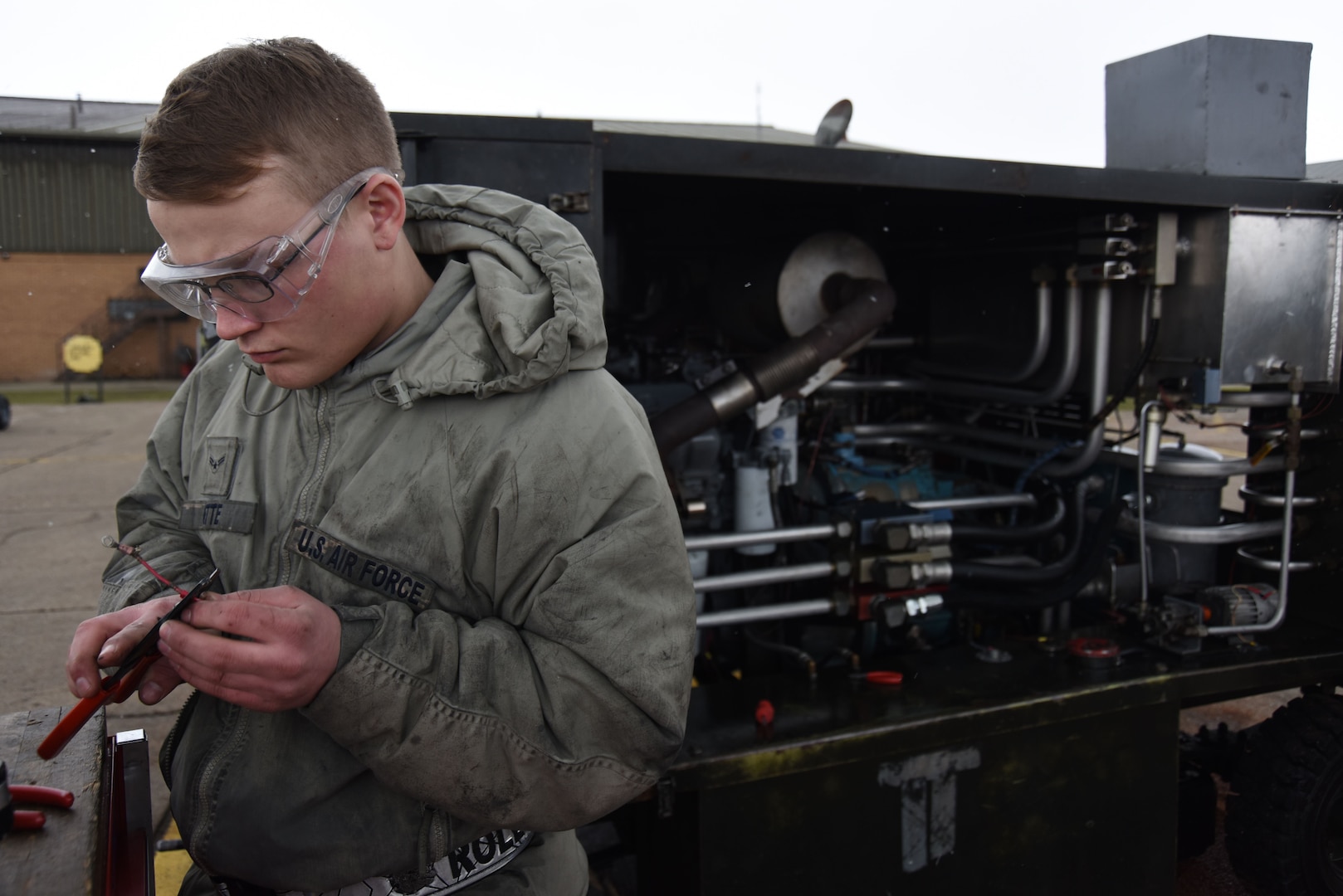 Airman 1st Class Nathan Gette, 48th Equipment Maintenance Squadron aerospace ground equipment technician, works to redo electrical wires for a hydraulic test stand at Royal Air Force Lakenheath, England, Feb. 7. AGE Airmen fix, maintain and perform routine maintenance on flightline equipment. (U.S. Air Force photo/Senior Airman Abby L. Finkel)