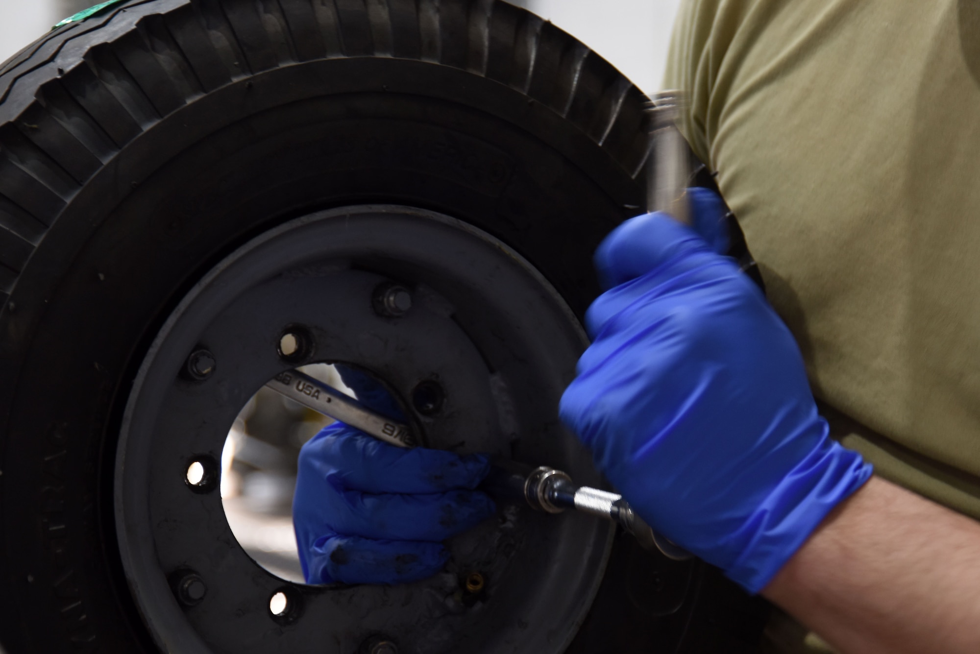 Senior Airman Nicholas Carcelli, 48th Equipment Maintenance Squadron aerospace ground equipment technician, replaces a bomb lift tire at Royal Air Force Lakenheath, England, Feb. 7. AGE technicians are responsible for fixing maintenance issues that arise on bomb lifts and other flightline equipment. (U.S. Air Force photo/Senior Airman Abby L. Finkel)