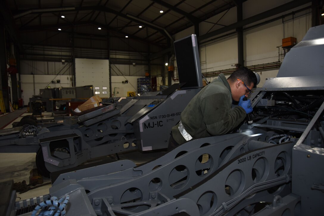 Airman 1st Class Andrei Perez, 48th Equipment Maintenance Squadron bomb lift maintainer, performs maintenance on a bomb lift at Royal Air Force Lakenheath, England, Feb. 7. AGE Airmen maintain flightline equipment such as generators, flood lights and bomb lifts. (U.S. Air Force photo/Senior Airman Abby L. Finkel)
