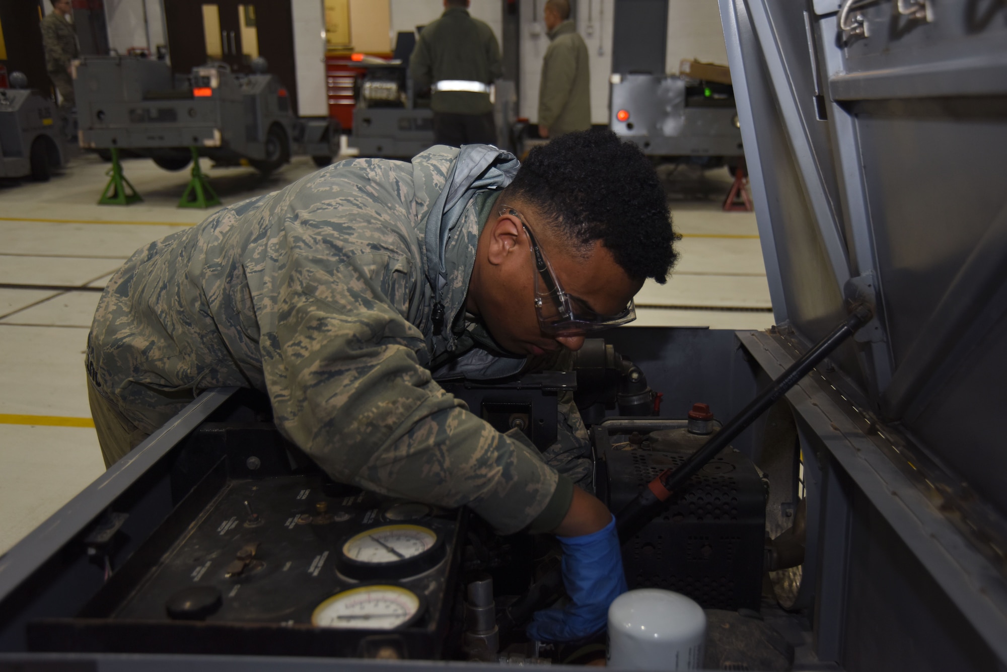 Senior Airman Michael St Rose, 48th Equipment Maintenance Squadron aerospace ground equipment technician, performs maintenance on an air compressor at Royal Air Force Lakenheath, England, Feb. 7. AGE Airmen maintain the equipment crew chiefs use on the flightline. (U.S. Air Force photo/Senior Airman Abby L. Finkel)