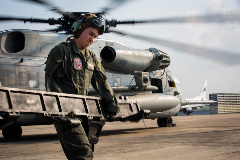 A U.S. Marine with Marine Heavy Helicopter Squadron 466 ‘Wolfpack’ unloads equipment from a CH-53E Super Stallion on the runway at U-Tapao International Airport, Kingdom of Thailand, Feb. 10, 2018. HMH-466 ‘Wolfpack’ arrive to the Kingdom of Thailand to participate in the 37th iteration of Cobra Gold as part of the U.S. Marine Corps Aviation Combat Element. The Super Stallion is assigned to HMH-466, Marine Aircraft Group 16, 3rd Marine Aircraft Wing, currently forward deployed under the unit deployment program with MAG-36, 1st MAW, based out of Okinawa, Japan. Exercise Cobra Gold 2018 is an annual exercise conducted in the Kingdom of Thailand held from Feb. 13-23 with seven full participating nations.