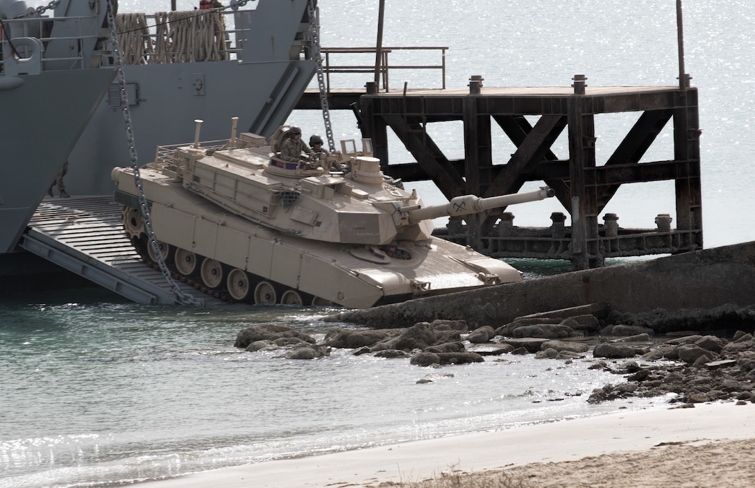 An M-1 Abrams Tank is unloaded onto the shore during Army Day 2018, Feb. 9, 2018, Kuwait Naval Base, Kuwait. Army Day was the opening event for U.S. Central Command’s Component Commanders Conference that allowed U.S. Army Central to showcase the Army’s capabilities at the theater level. (U.S. Army photo by Sgt. 1st Class Ty McNeeley, U.S. ARCENT PAO)